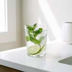 Glass of iced water on a clean bathroom counter illustrating cold tooth sensitivity