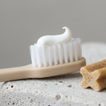 Pet toothbrush with paste beside a dental chew showing dental chews vs toothpaste for dogs